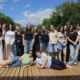 Schülerinnen und Schüler auf einem Floß auf der Mur mit ihren Lehrkräften bei Sonneschein